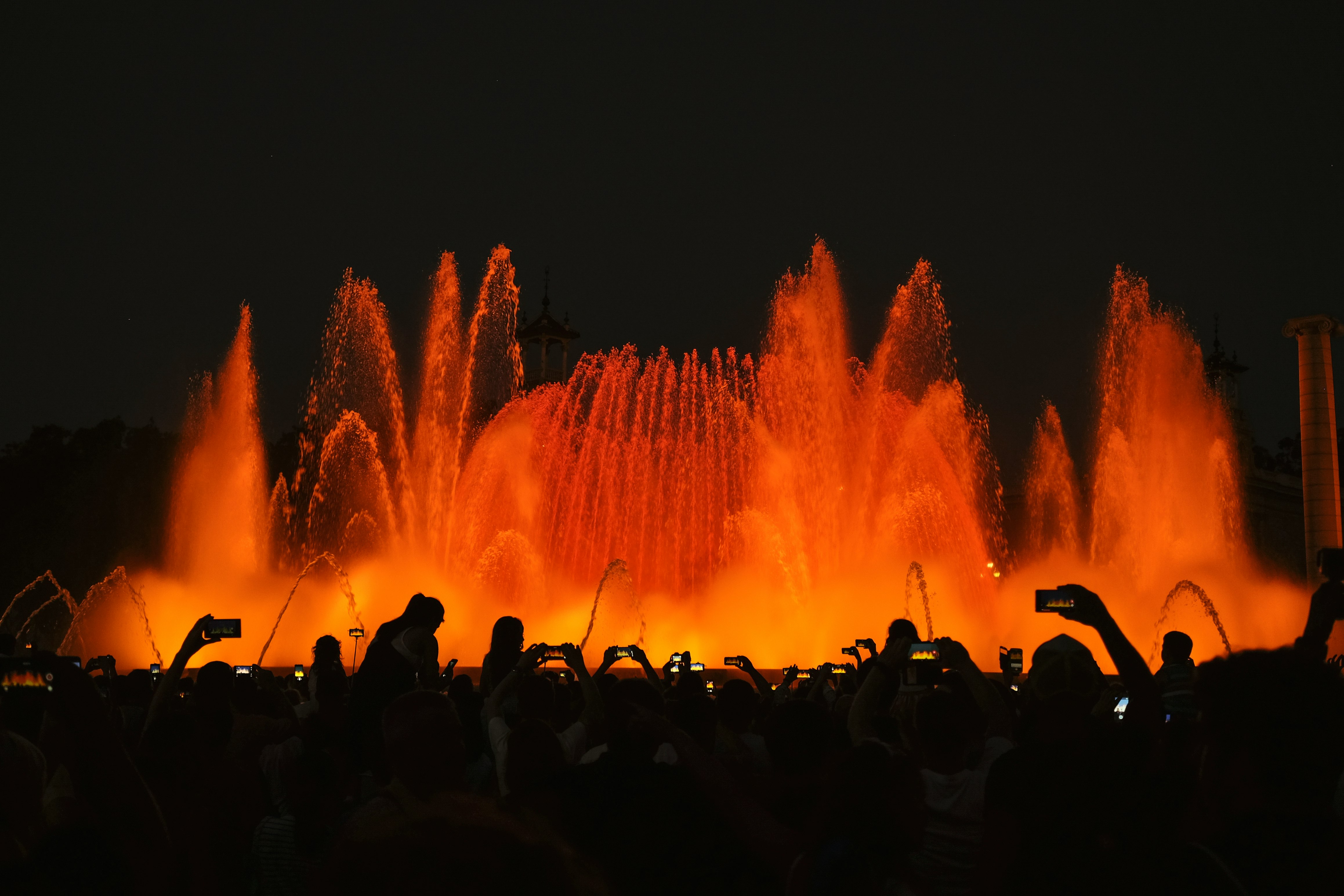 silhouette photography of people in front of water fountain